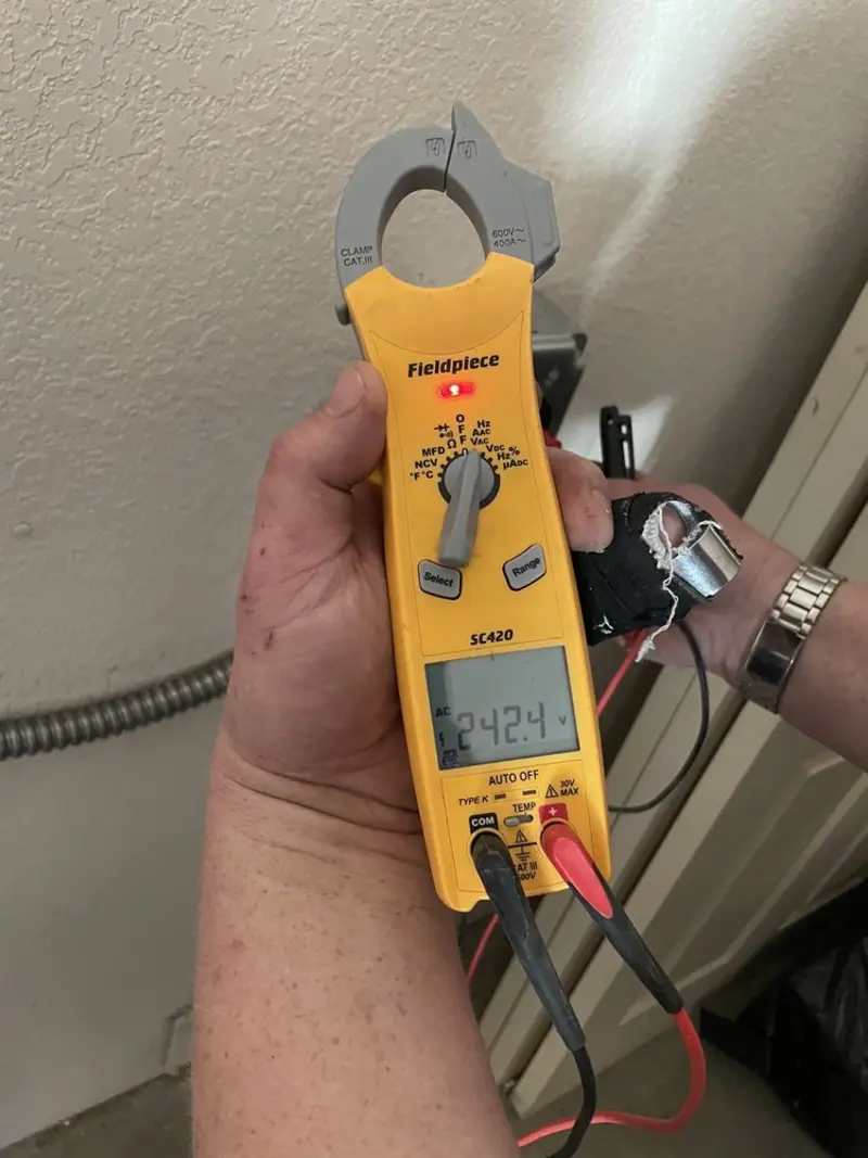 Voltage testing with clamp meter during Ceiling Fan Installation in Estero